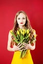 Young Beautiful Blonde Woman with Yellow Tulip Flowers Royalty Free Stock Photo