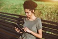 Cheerful black gril calling her friend using tablet pc