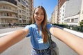 Young beautiful Brazilian woman with stylish wears takes self portrait on Minhocao highway on sunday in Sao Paulo, Brazil