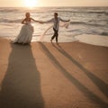 Young beautiful bridal couple having fun together at the beach