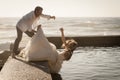 Young beautiful bridal couple having fun together at the beach Royalty Free Stock Photo