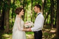 Young and beautiful bride and bridegroom holding one another hands