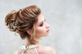 Young beautiful bride with an elegant high hairdo. Wedding hairstyle with the accessory in her hair Royalty Free Stock Photo