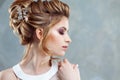 Young beautiful bride with an elegant high hairdo. Wedding hairstyle with the accessory in her hair Royalty Free Stock Photo