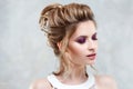 Young beautiful bride with an elegant high hairdo. Wedding hairstyle with the accessory in her hair Royalty Free Stock Photo