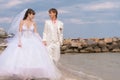 Young and beautiful bride and groom on the beach Royalty Free Stock Photo