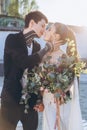 young beautiful bride and groom embracing and kissing