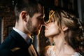 Young and beautiful bride and groom kiss, indoors Royalty Free Stock Photo