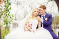 Young and beautiful bride and groom sitting on a white swing in Royalty Free Stock Photo