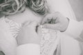 Young beautiful bride and male hands buttoning wedding dress Royalty Free Stock Photo