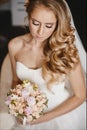 Young and beautiful bride, sensual blond model girl with gentle makeup and with wedding hairstyle in the white dress Royalty Free Stock Photo