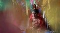 A young beautiful bride is sitting and watching a special puja ceremony on her wedding day in Kathmandu, Nepal