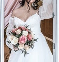 young beautiful bride in a white delicate elegant airy wedding dress with a bouquet of flowers rose Royalty Free Stock Photo