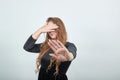 Girl brown haired in black dress over isolated white background shows emotions Royalty Free Stock Photo