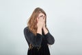 Girl brown haired in black dress over isolated white background shows emotions Royalty Free Stock Photo