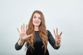 Girl brown haired in black dress over isolated white background shows emotions Royalty Free Stock Photo