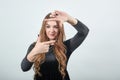 Girl brown haired in black dress over isolated white background shows emotions Royalty Free Stock Photo