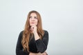 Girl brown haired in black dress over isolated white background shows emotions Royalty Free Stock Photo