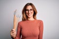 Young beautiful brunette artist woman holding painter brushes over white background with a happy face standing and smiling with a Royalty Free Stock Photo