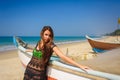 Young Beautiful Brunette In Beach Dress On Blue Sea Near Wooden Fishing Boat. Summer Tropical Relaxation Outdoor, Carefree