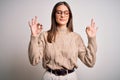 Young beautiful brunette businesswoman wearing casual sweater and glasses standing relax and smiling with eyes closed doing Royalty Free Stock Photo