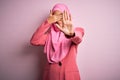 Young beautiful brunette businesswoman wearing pink muslim hijab and business jacket covering eyes with hands and doing stop Royalty Free Stock Photo