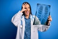 Young beautiful brunette doctor woman wearing stethoscope holding chest xray with happy face smiling doing ok sign with hand on