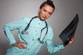 Young beautiful brunette doctor woman wearing stethoscope holding chest xray with a happy face standing and smiling with Royalty Free Stock Photo