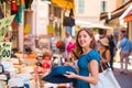 Young and beautiful brunette girl in dress and hat walking outdoor at the market. Nice, France. Summer vacation Royalty Free Stock Photo