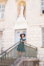 Young and beautiful brunette girl in dress and hat walking outdoor in the Old Town. Nice, France. Summer vacation Royalty Free Stock Photo