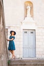 Young and beautiful brunette girl in dress and hat walking outdoor in the Old Town. Nice, France. Summer vacation Royalty Free Stock Photo