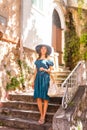 Young and beautiful brunette girl in dress and hat walking outdoor in the street. Nice, France. Summer vacation Royalty Free Stock Photo