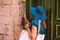 Young and beautiful brunette girl in dress and hat walking outdoor in the street. Nice, France. Summer vacation Royalty Free Stock Photo