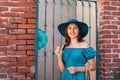 Young and beautiful brunette girl in dress and hat walking outdoor in the street. Nice, France. Summer vacation Royalty Free Stock Photo