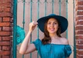 Young and beautiful brunette girl in dress and hat walking outdoor in the street. Nice, France. Summer vacation Royalty Free Stock Photo