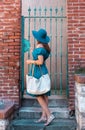 Young and beautiful brunette girl in dress and hat walking outdoor in the street. Nice, France. Summer vacation Royalty Free Stock Photo
