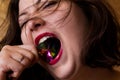 Young beautiful brunette girl with the gemstone in her mouth Royalty Free Stock Photo