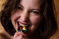 Young beautiful brunette girl with the gemstone in her mouth Royalty Free Stock Photo