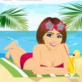 Young beautiful brunette girl lying on beach towel with cocktail Royalty Free Stock Photo