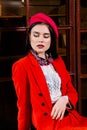 beautiful brunette girl in a red suit, white shirt and red beret Royalty Free Stock Photo