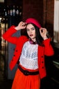 Beautiful brunette girl in a red suit, white shirt and red beret Royalty Free Stock Photo