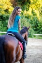 Young beautiful brunette girl riding a horse. Royalty Free Stock Photo