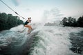 Young beautiful girl riding on the wakesurf holding a rope of a Royalty Free Stock Photo