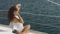 Young beautiful brunette girl sitting on the luxury yacht Royalty Free Stock Photo