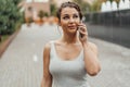 Young brunette girl talking by mobile phone in park at summer time. Royalty Free Stock Photo