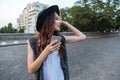 Young beautiful brunette girl using her smart phone outdoors Royalty Free Stock Photo