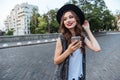 Young beautiful brunette girl using her smart phone outdoors Royalty Free Stock Photo