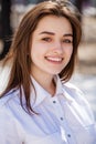 Young beautiful brunette girl in white shirt posing on spring park Royalty Free Stock Photo