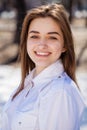 Young beautiful brunette girl in white shirt posing on spring park Royalty Free Stock Photo