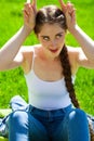 Young beautiful brunette girl in white shirt posing on spring park Royalty Free Stock Photo